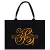a black shopping bag with a gold logo