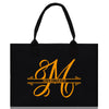 a black shopping bag with the letter m on it