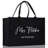 a black shopping bag with the words mrs fetcher on it