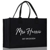 a black shopping bag with the words mrs harris on it