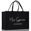 a black shopping bag with the words mrs spencer on it