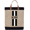 a black and white tote bag with the word kim on it