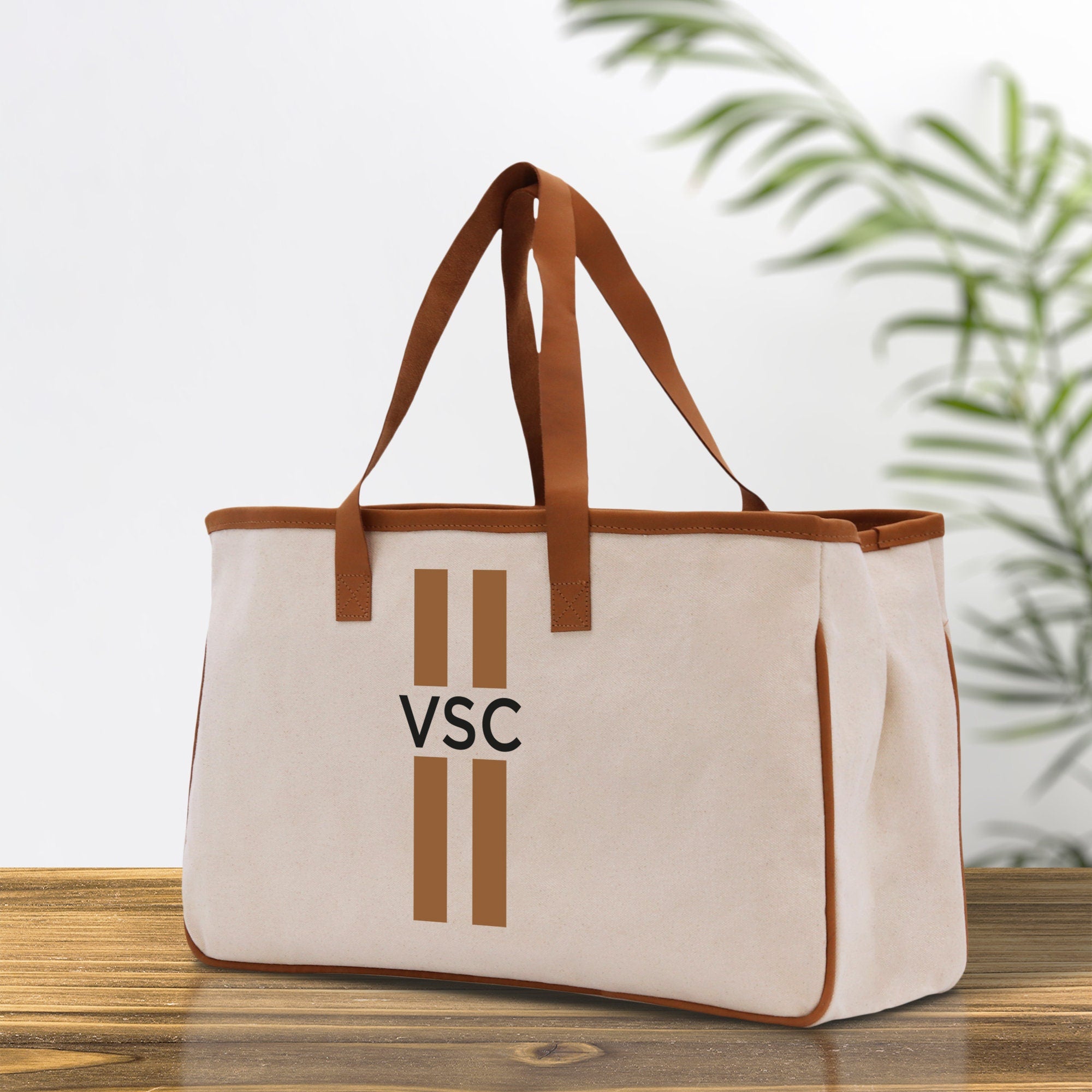 a canvas tote bag with a brown leather strap