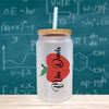 a glass jar with a straw in front of a chalkboard