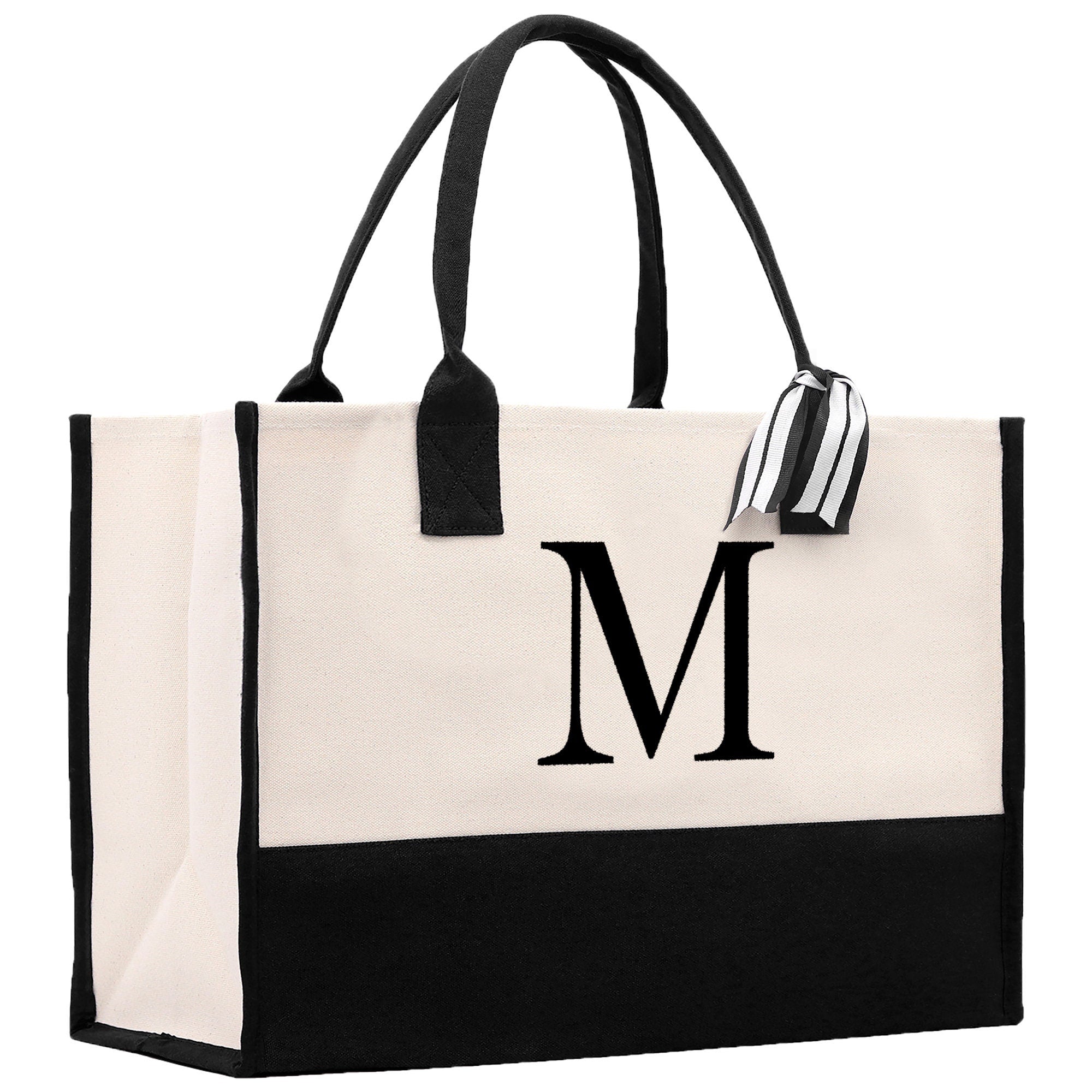 a black and white tote bag with the letter m on it