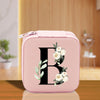 a pink lunch box with a floral monogrammed initial