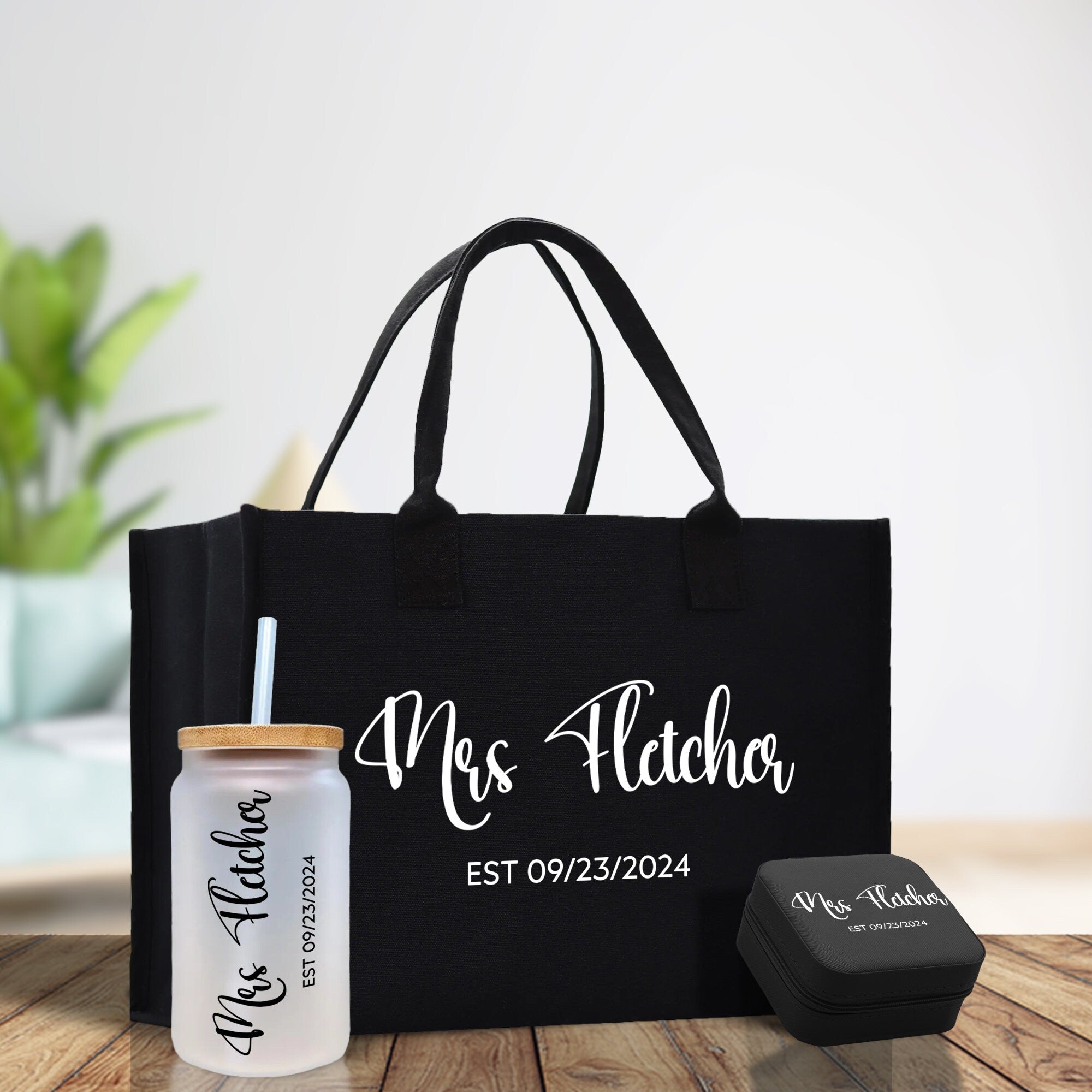 a black tote bag with a personalized drink next to it