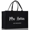 a black shopping bag with the words mrs harris on it