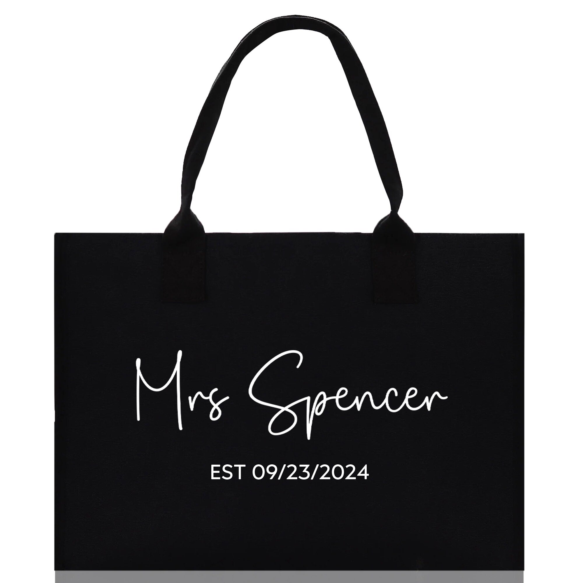 a black shopping bag with the words mrs spencer on it