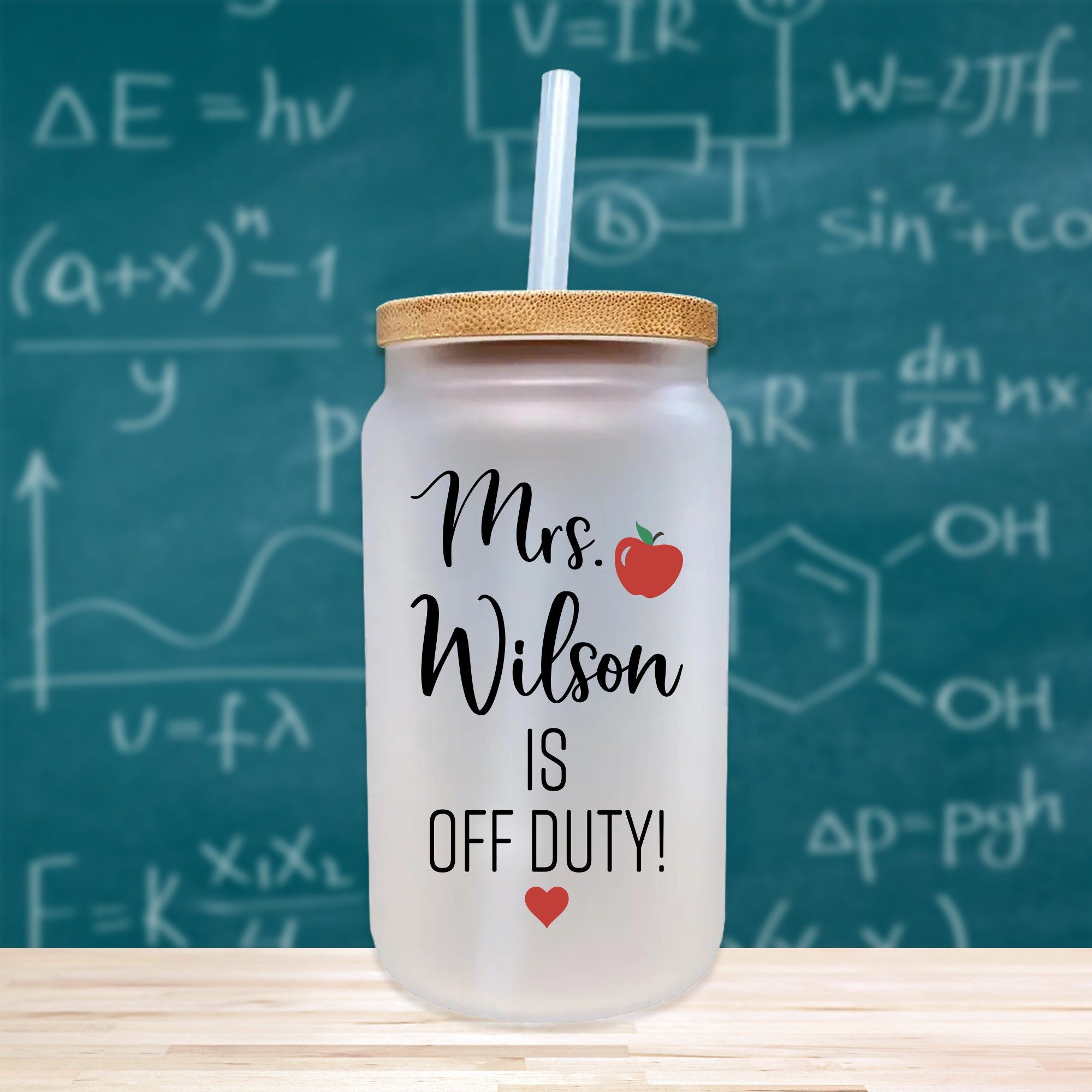 a mason jar with a straw in front of a chalkboard