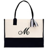 a black and white tote bag with a monogrammed bow