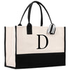 a black and white tote bag with the letter d on it