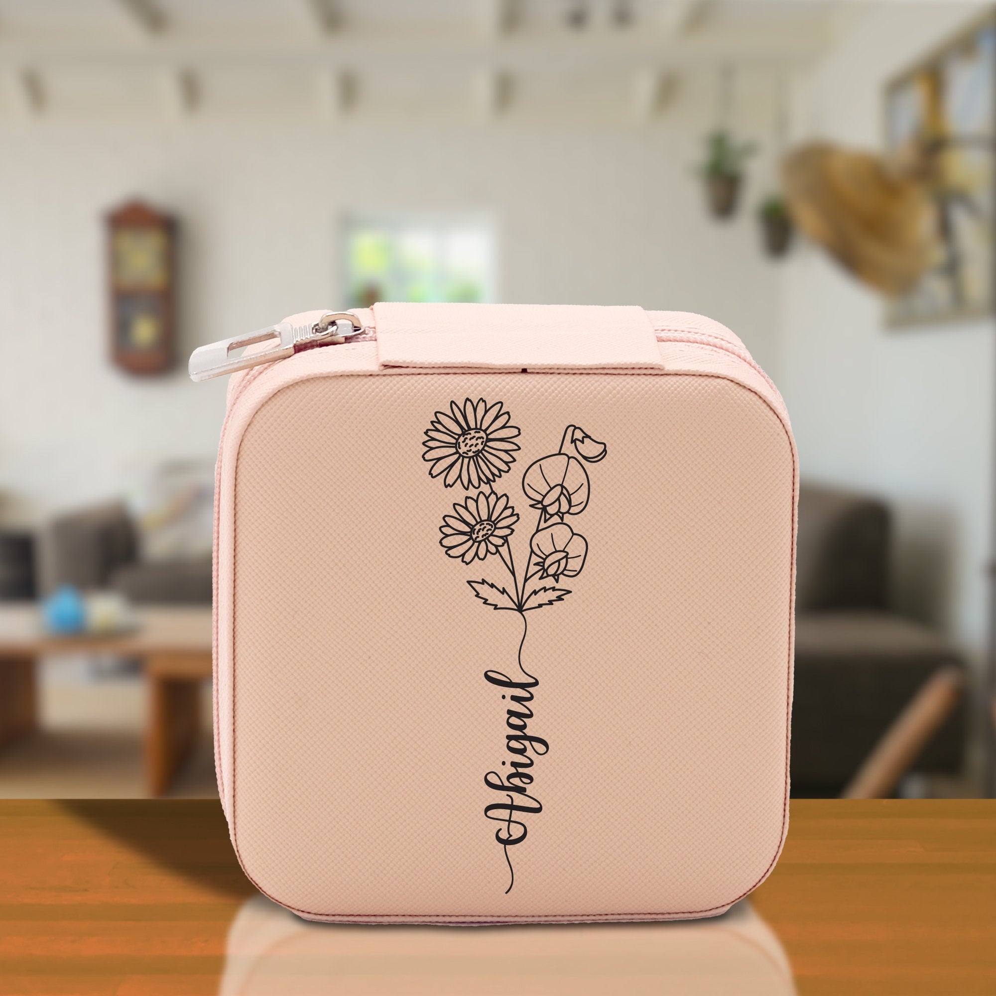 a pink lunch box with a flower drawn on it