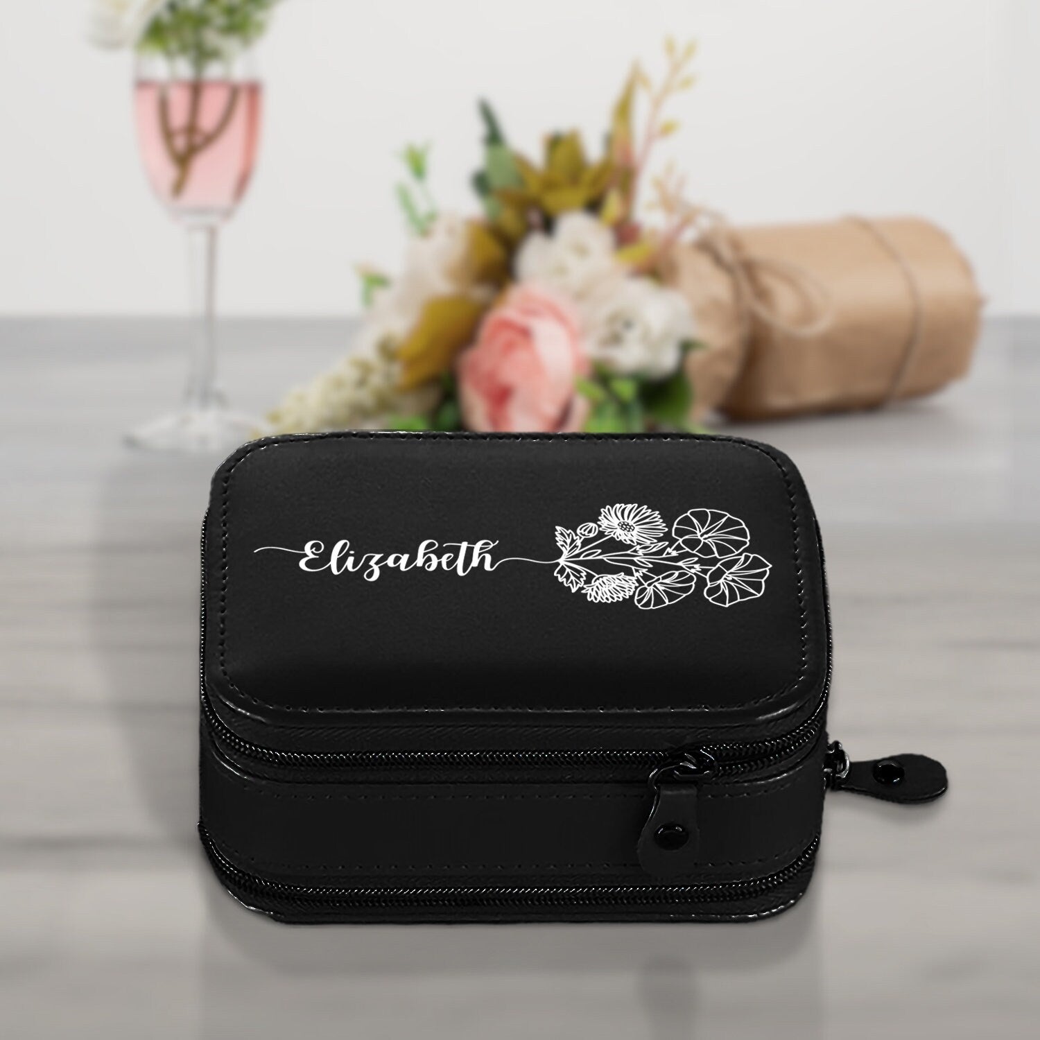 a black cosmetic bag sitting on top of a table